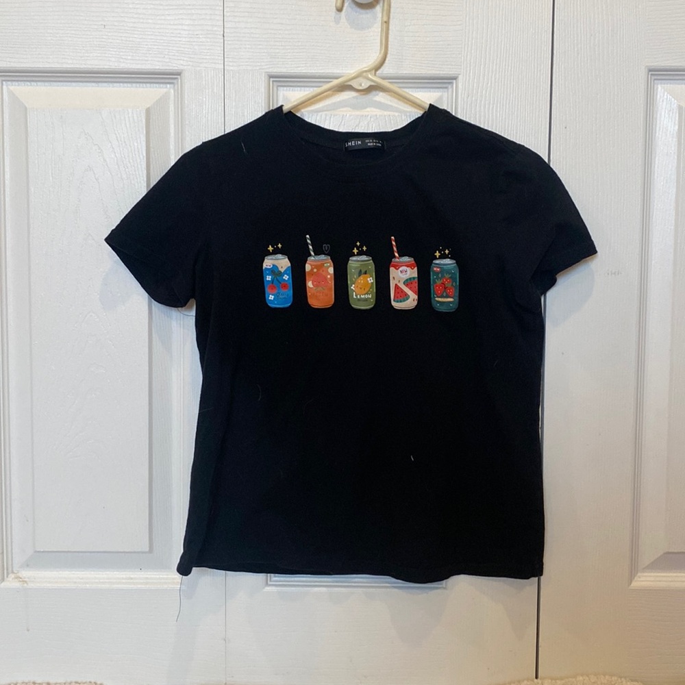 black graphic tee with soda fruit cans